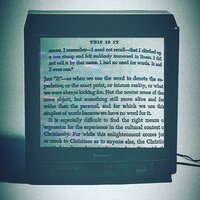 a picture of a book inside a television - Aptato