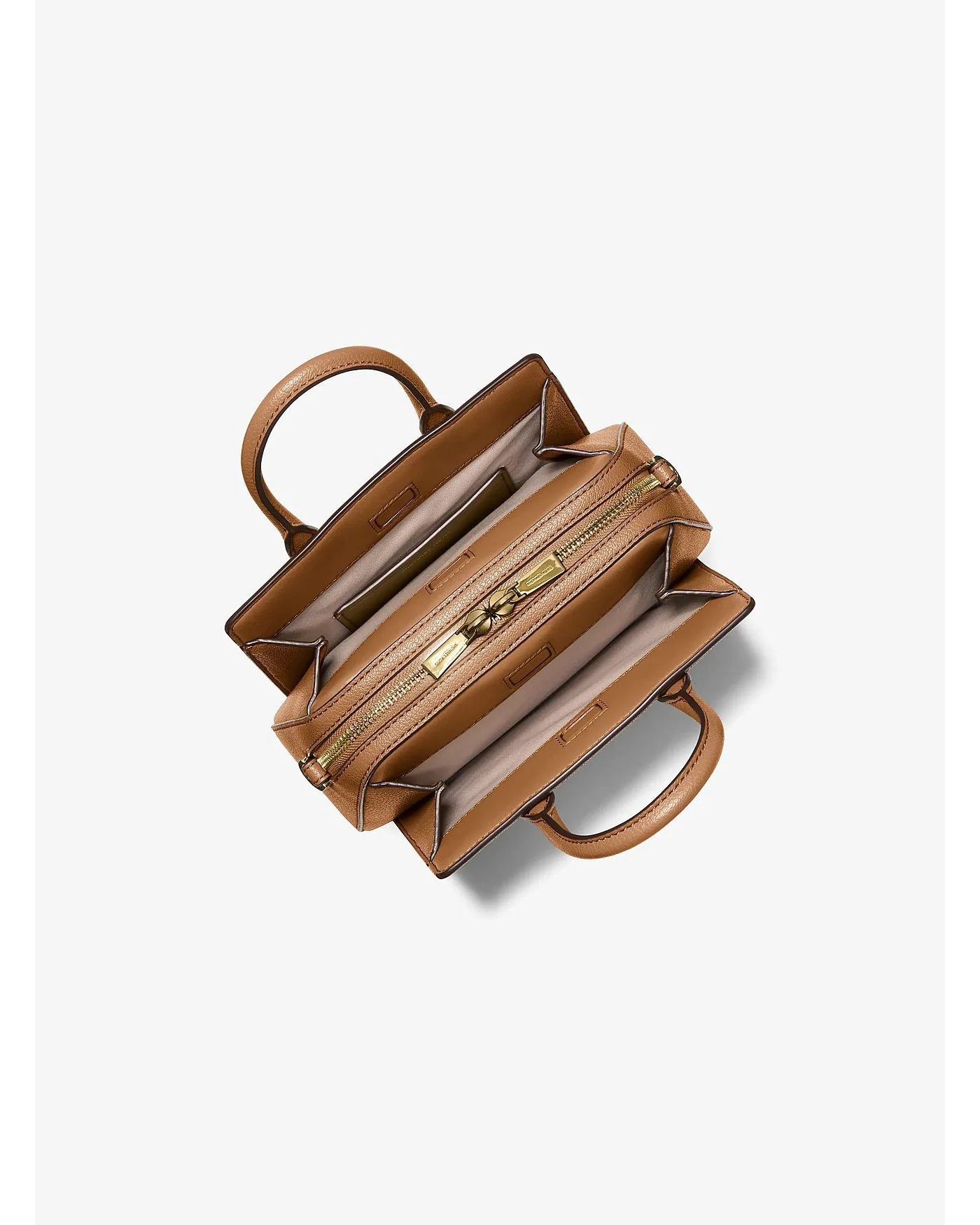 Открытое внутреннее отделение сумки Michael Kors с золотистой молнией.