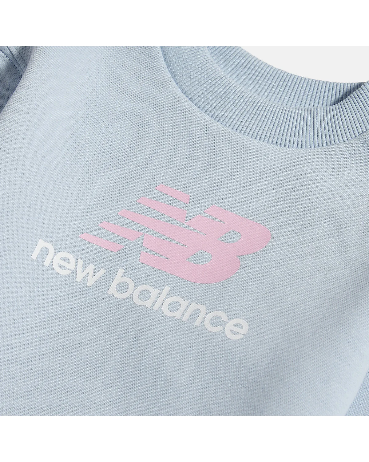 Крупный план розового логотипа New Balance на голубом свитшоте