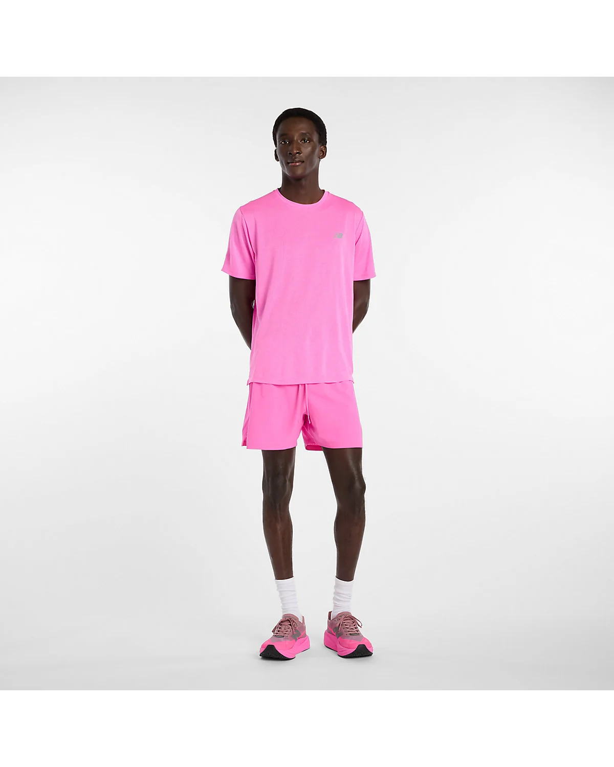 Розовые беговые шорты New Balance на модели в полный рост, вид спереди
