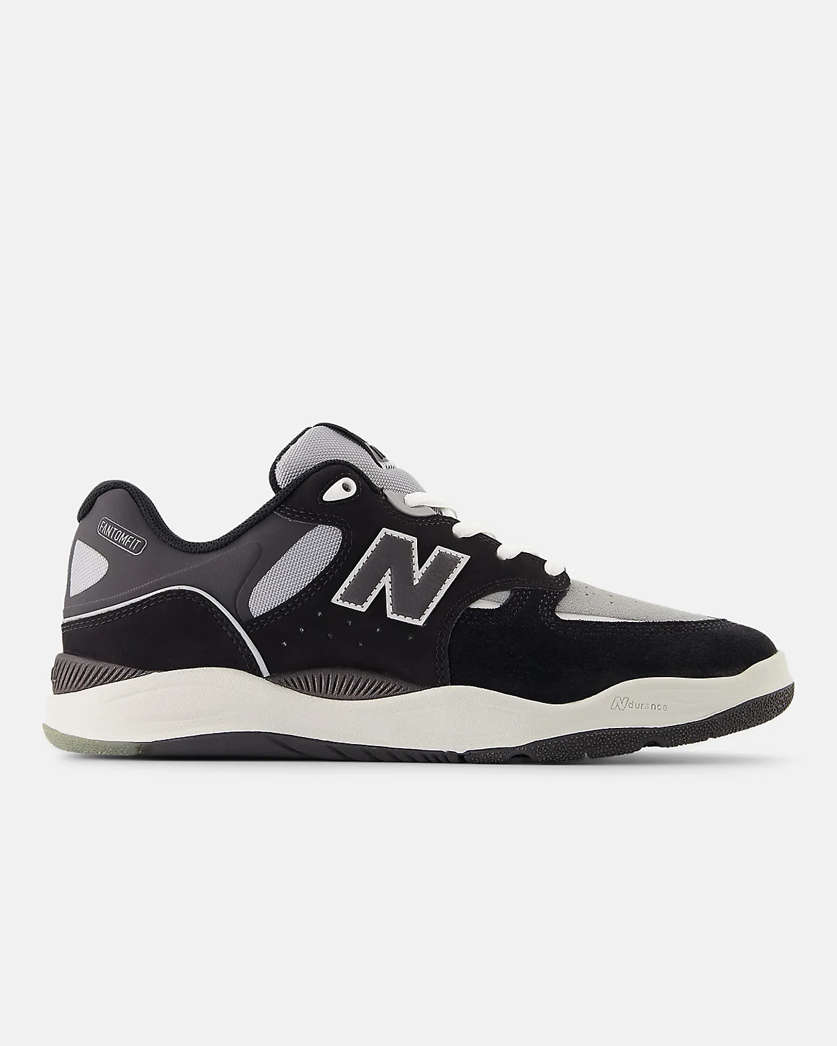 Глиняно-оранжевые кроссовки New Balance 1010 с чёрными панелями, вид сбоку.