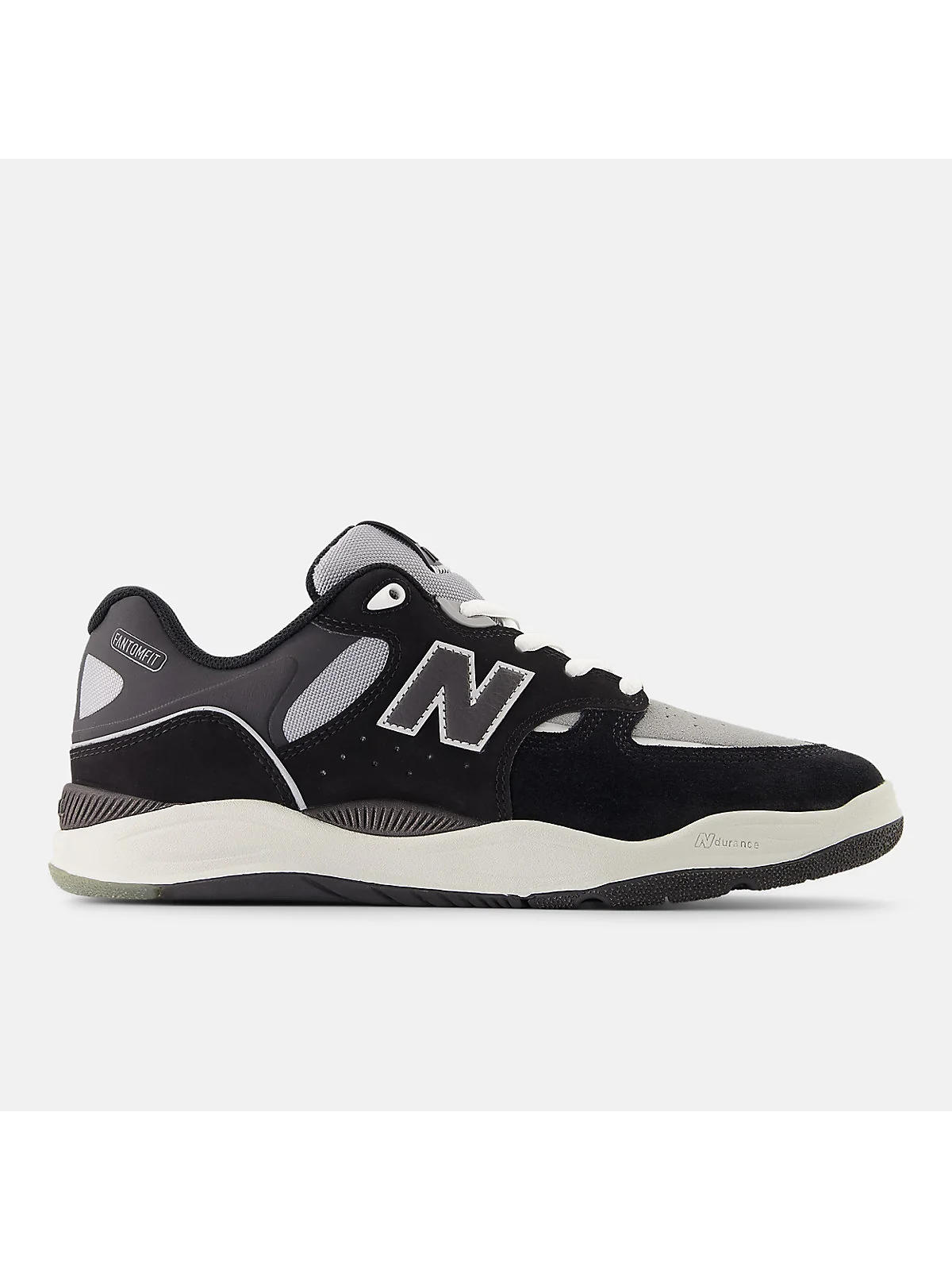 Глиняно-оранжевые кроссовки New Balance 1010 с чёрными панелями, вид сбоку.