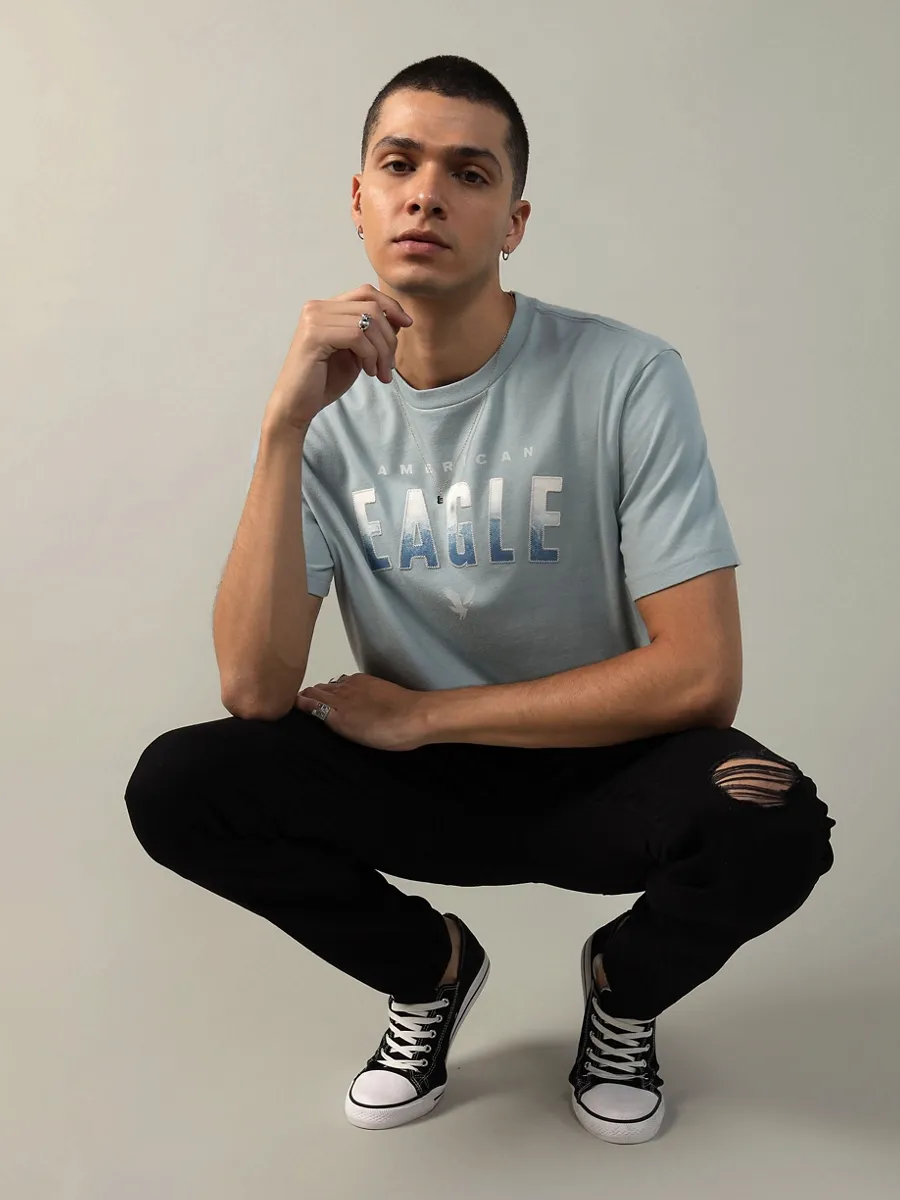 AMERICAN EAGLE MEN G SS INTL ELEVATED SET IN TEE- PC DYE + SERIOUSLY SOFT WASH 401 LIGHT BLUE