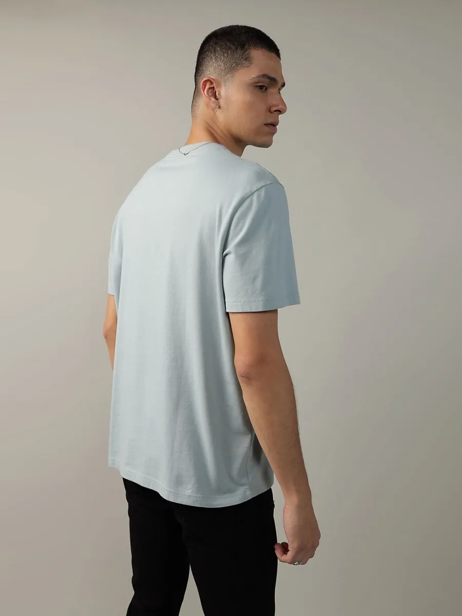 AMERICAN EAGLE MEN G SS INTL ELEVATED SET IN TEE- PC DYE + SERIOUSLY SOFT WASH 401 LIGHT BLUE